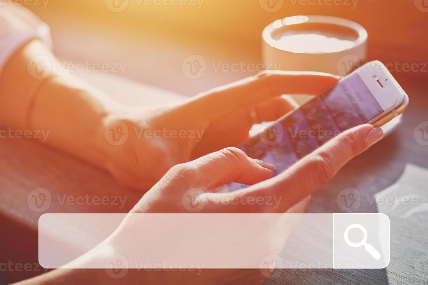 Woman in cafe using smartphone to search data online photo