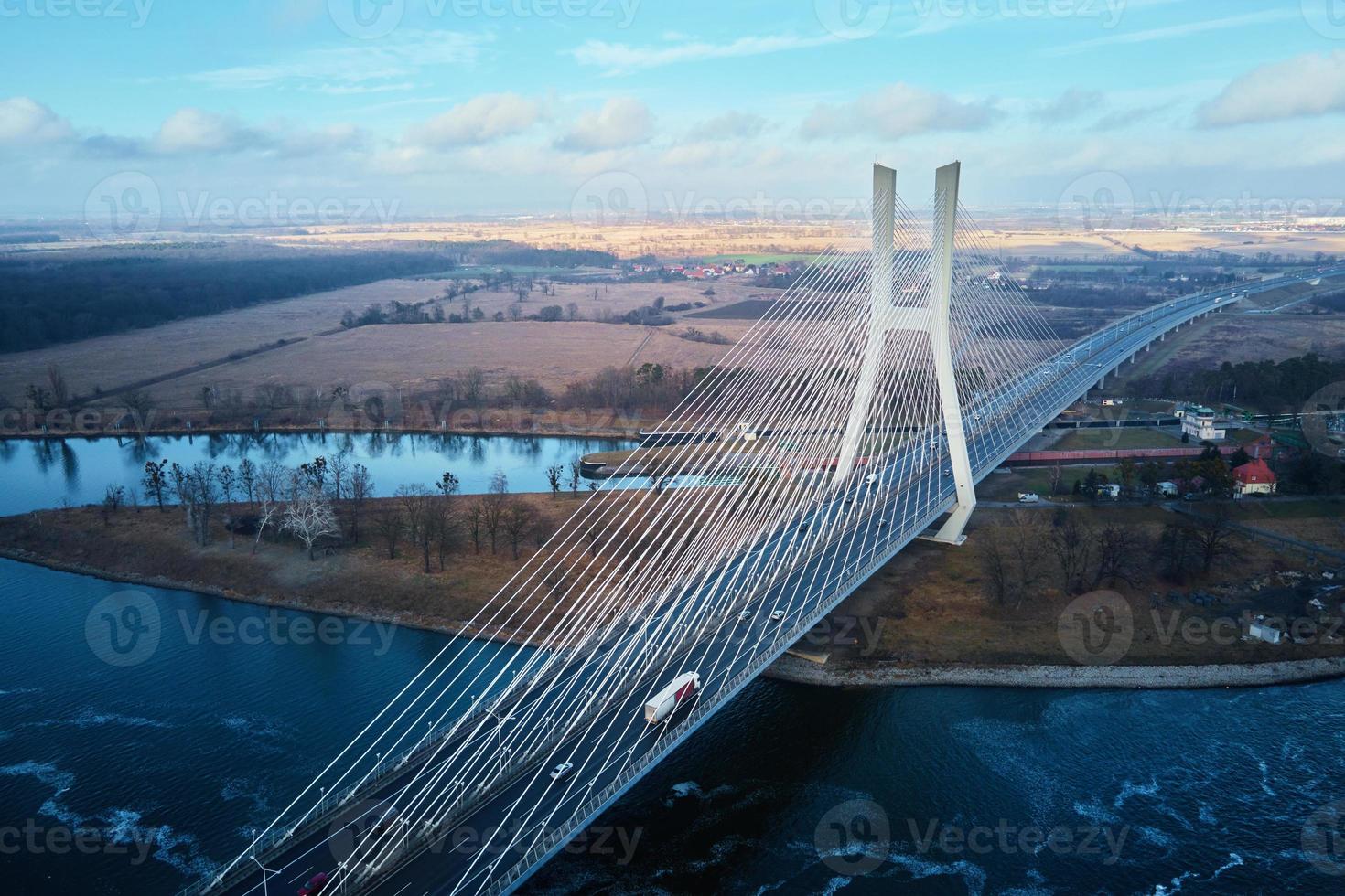 Large bridge over river with cars traffic photo
