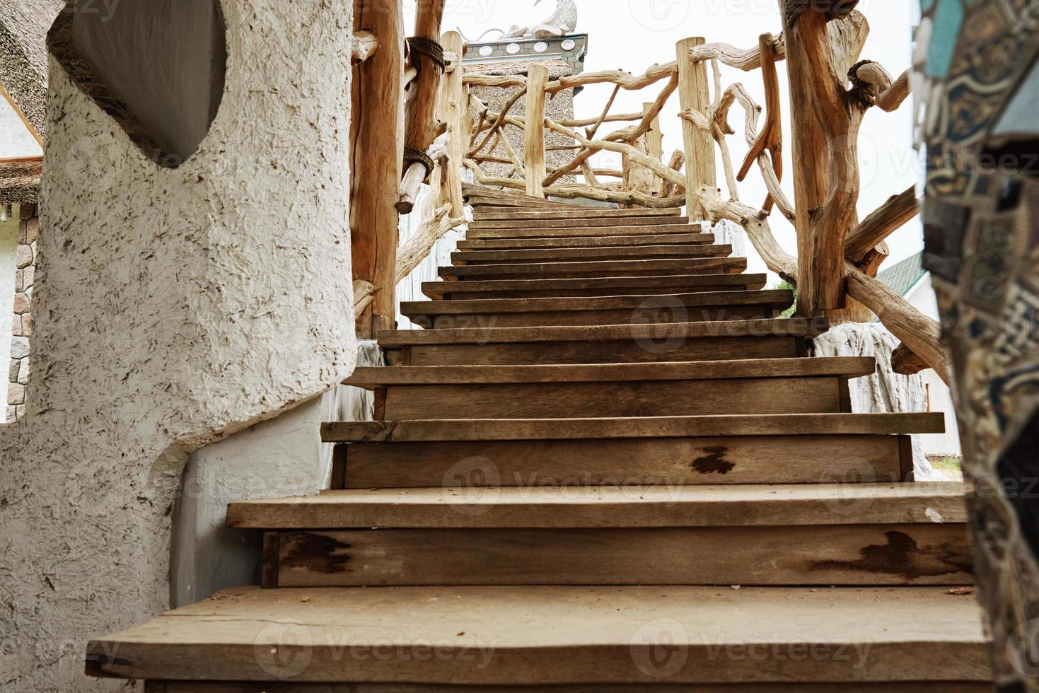 Old wooden staircase with railings outdoors photo