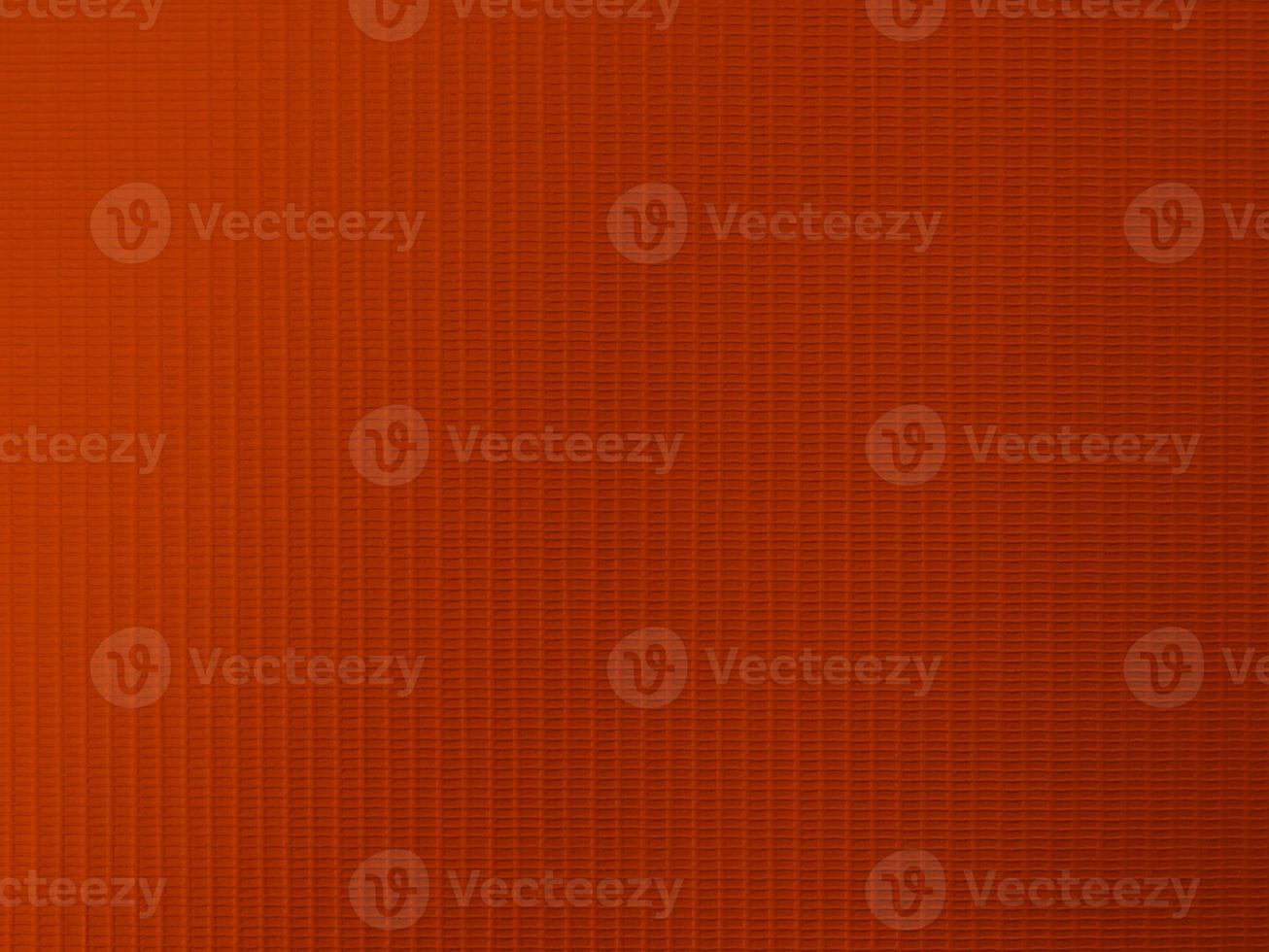textura de tela de terciopelo naranja utilizada como fondo. fondo de tela de color naranja de material textil suave y liso. hay espacio para texto y para todo tipo de trabajo de diseño. foto