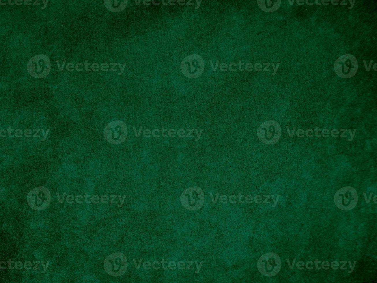 Dark green old velvet fabric texture used as background. Empty green fabric background of soft and smooth textile material. There is space for text.. photo