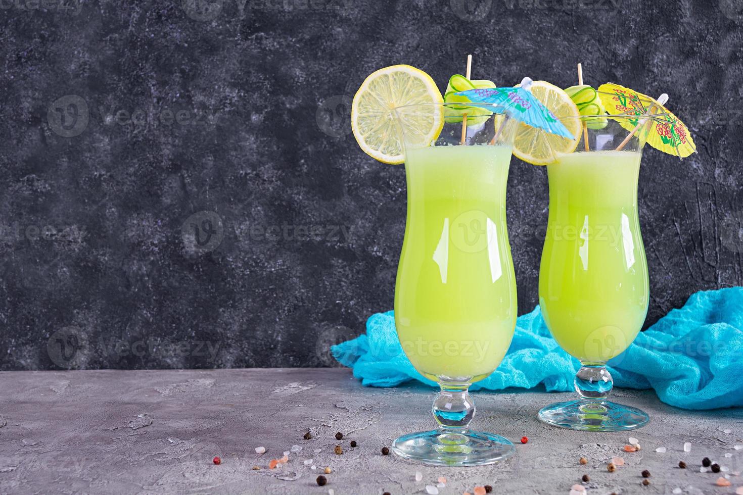 Glass of fresh cucumber juice. Cocktail with cucumber, ice and lemon