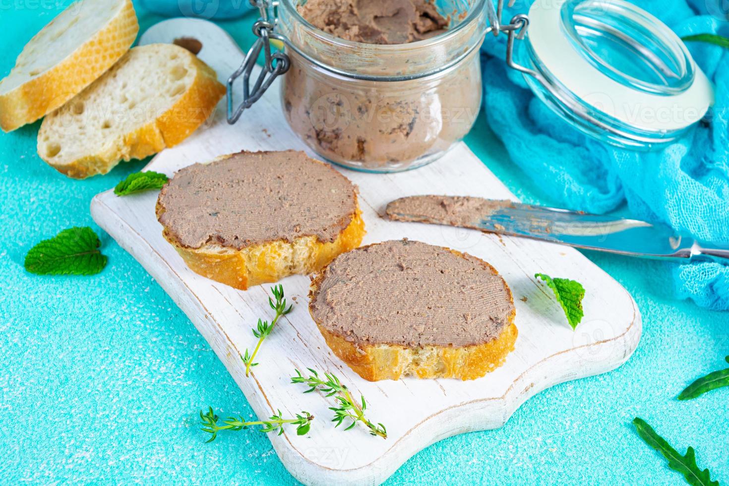 Sandwich with chicken liver pate on blue background photo