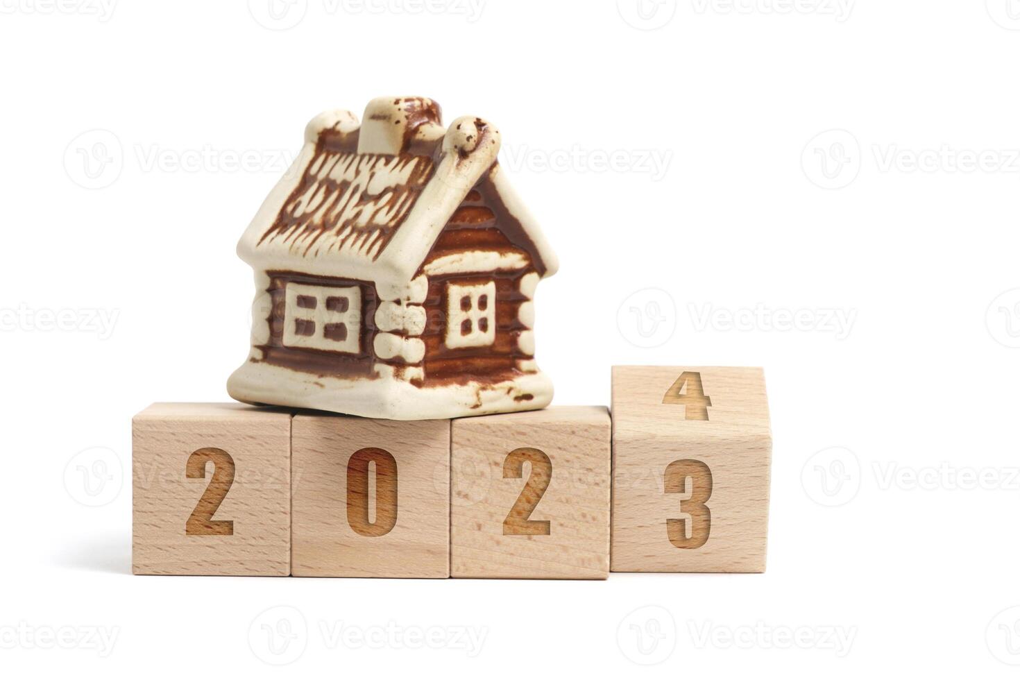Wooden cubes with inscription 2023 turning into 2024 and house on white