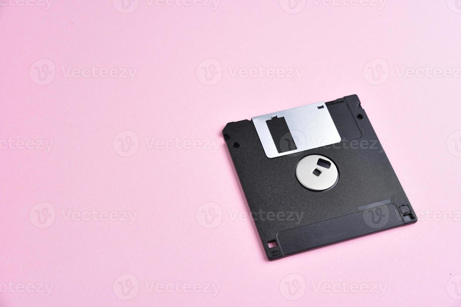 Floppy disk on pink background photo