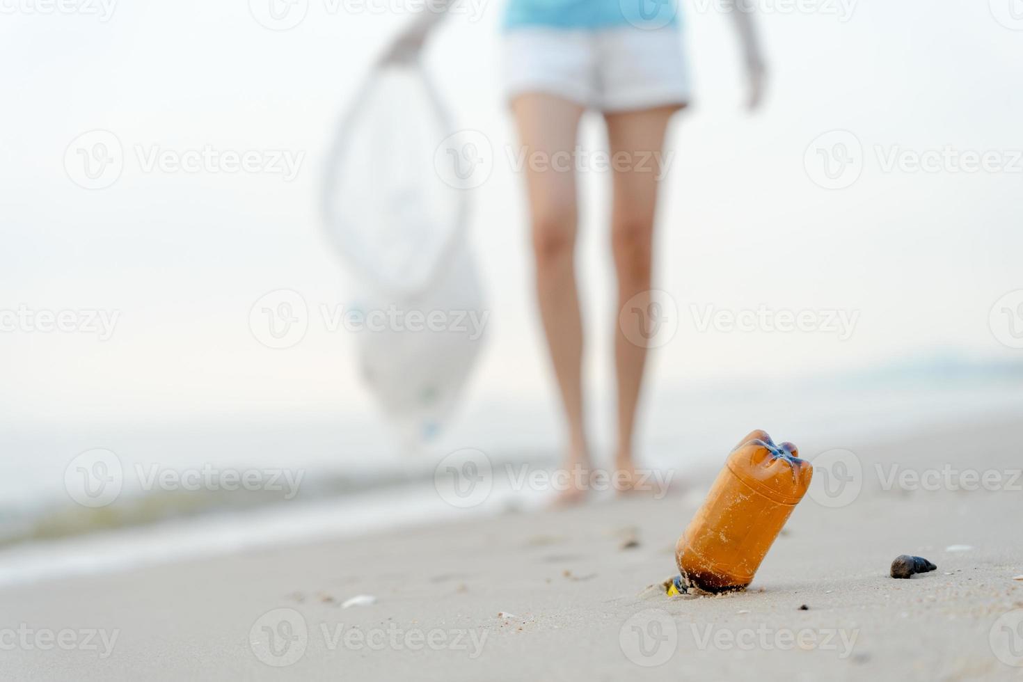 Save water. Volunteer pick up trash garbage at the beach and plastic bottles are difficult decompose prevent harm aquatic life. Earth, Environment, Greening planet, reduce global warming, Save world photo