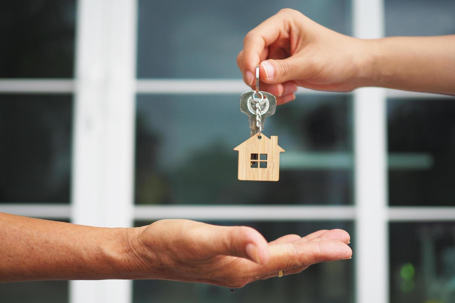 Home buyers are taking home keys from sellers. Sell your house, rent house and buy ideas. photo