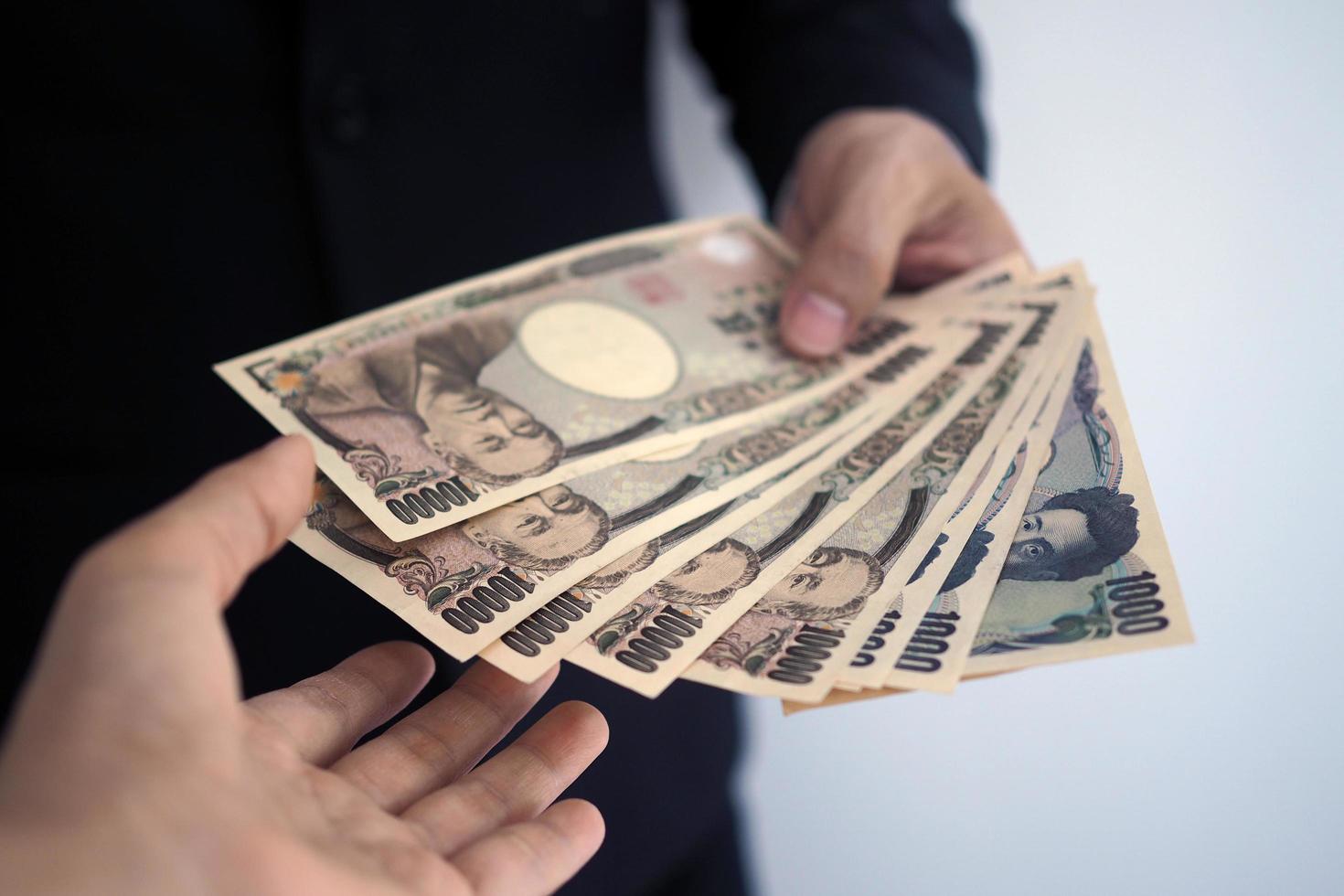 Businessmen send Japanese banknotes to employees. photo