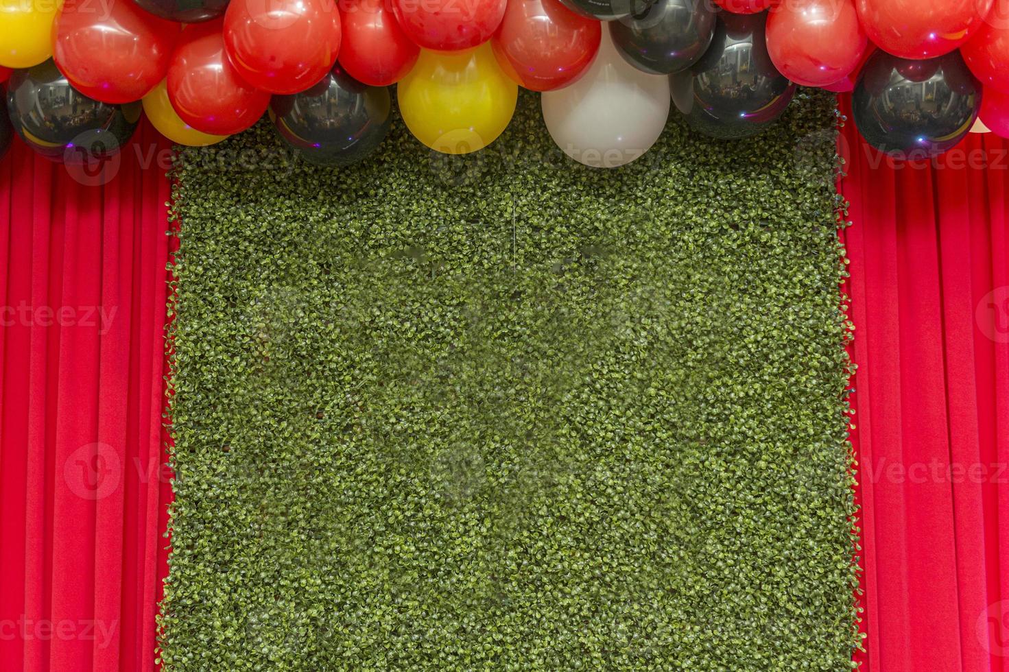 Beautiful green wall grass panel with colorful balloons photo