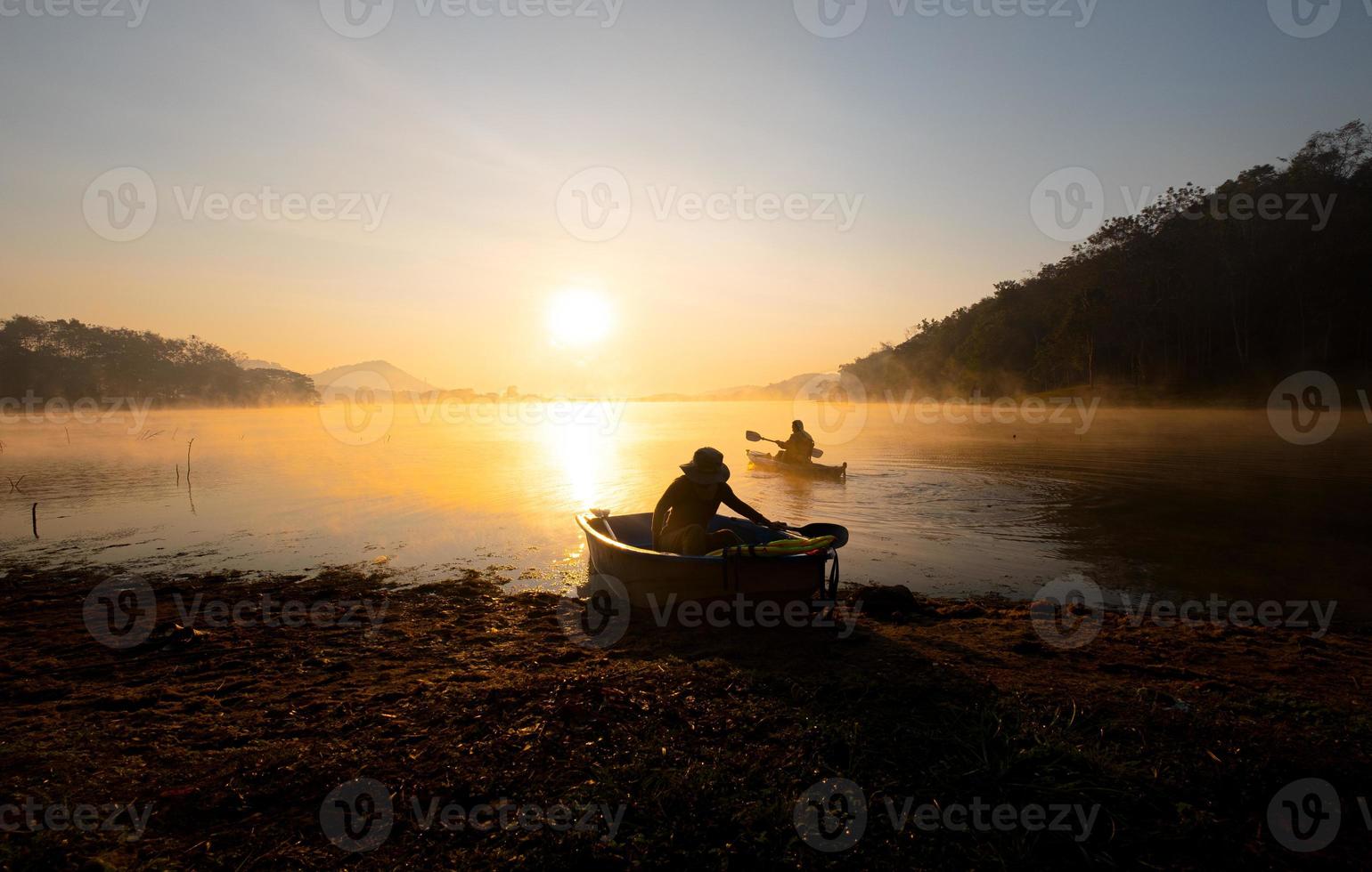 Women on kayak rows in the reservoir during the sunrise, Harirak forest park Huai Nam Man reservoir Loei Thailand 21 Jan 2023 photo