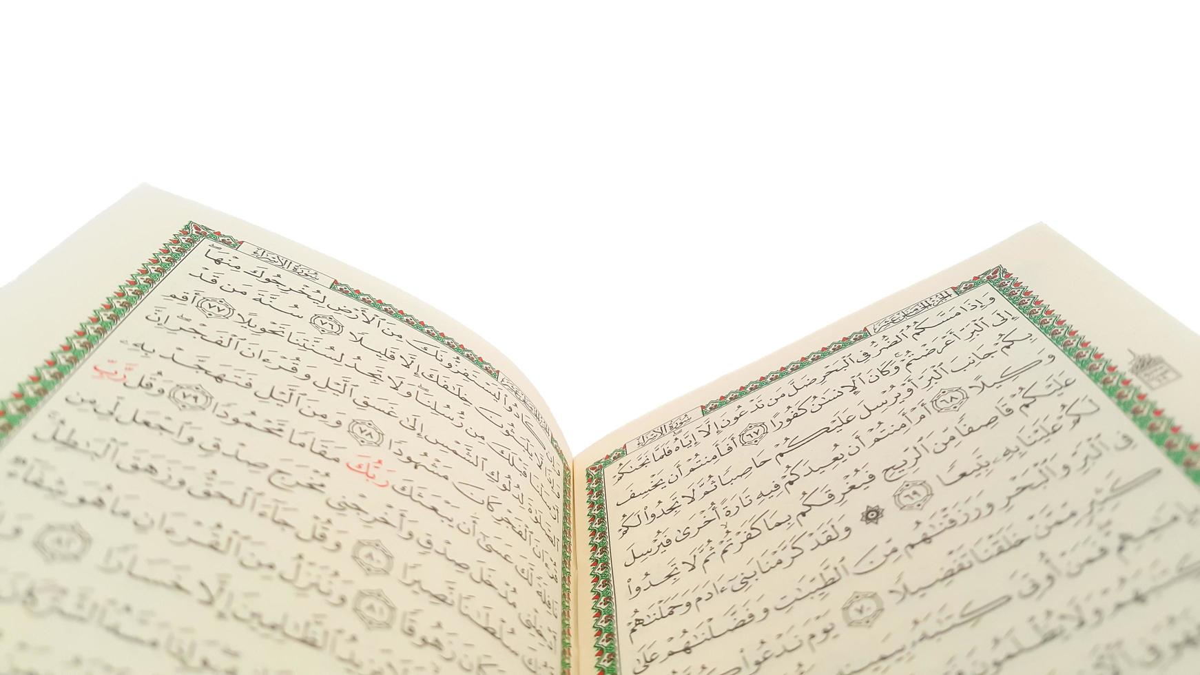 Open Quran pages with white background. Surah Al Baqarah. Arabic letters. Selective focus on letters. Al-Quran is a holy book of Islamic guidance isolated. Religion concept. photo