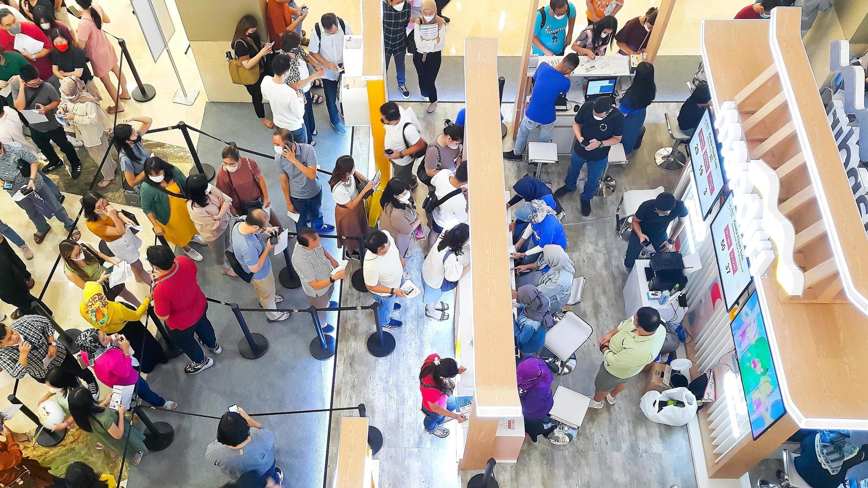 Jakarta, Indonesia, February 04, 2023 - Top view of queue of people at an exhibition in a shopping mall photo