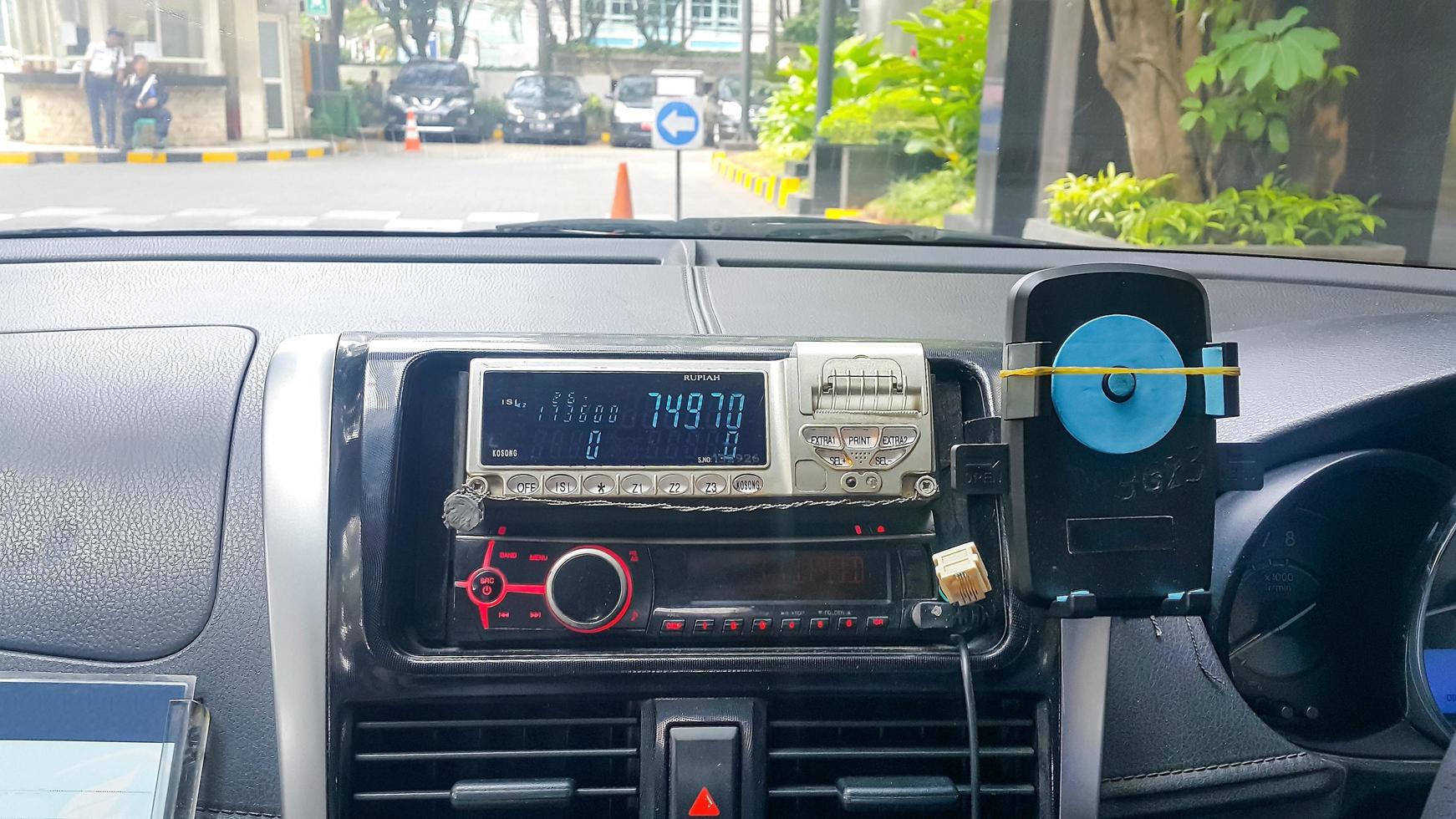 Taxi meter and dashboard interior. View from backseats. photo