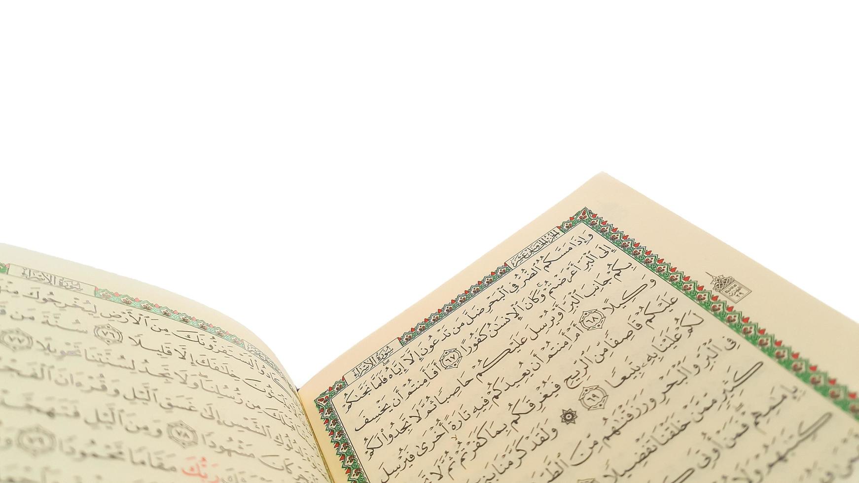 Open Quran pages with white background. Surah Al Baqarah. Arabic letters. Selective focus on letters. Al-Quran is a holy book of Islamic guidance isolated. Religion concept. photo