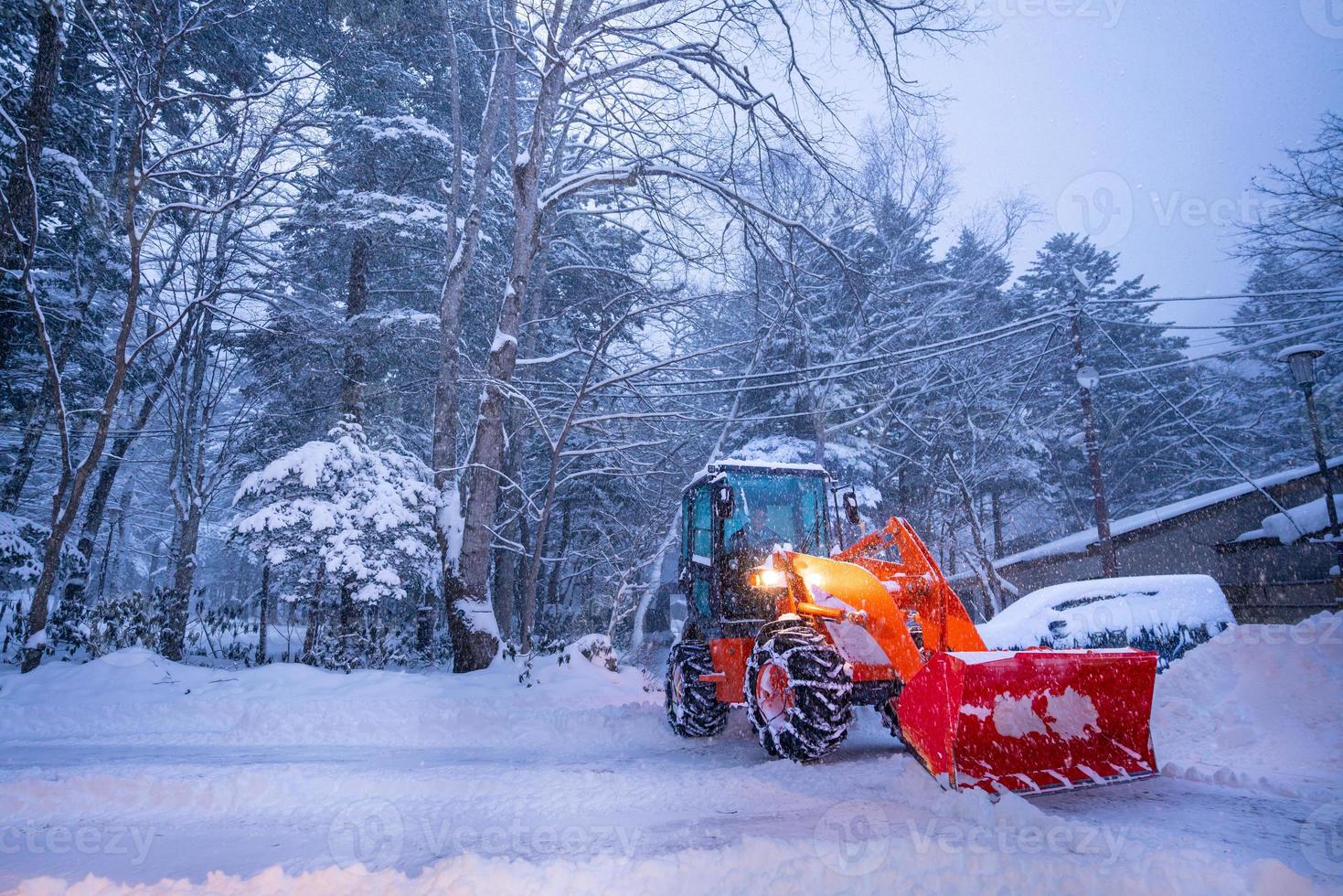 snow shovel tractor on a heavy snowy day at Heike No Sato Village in Tochigi Prefecture, Nikko City, JAPAN. soft focus. photo
