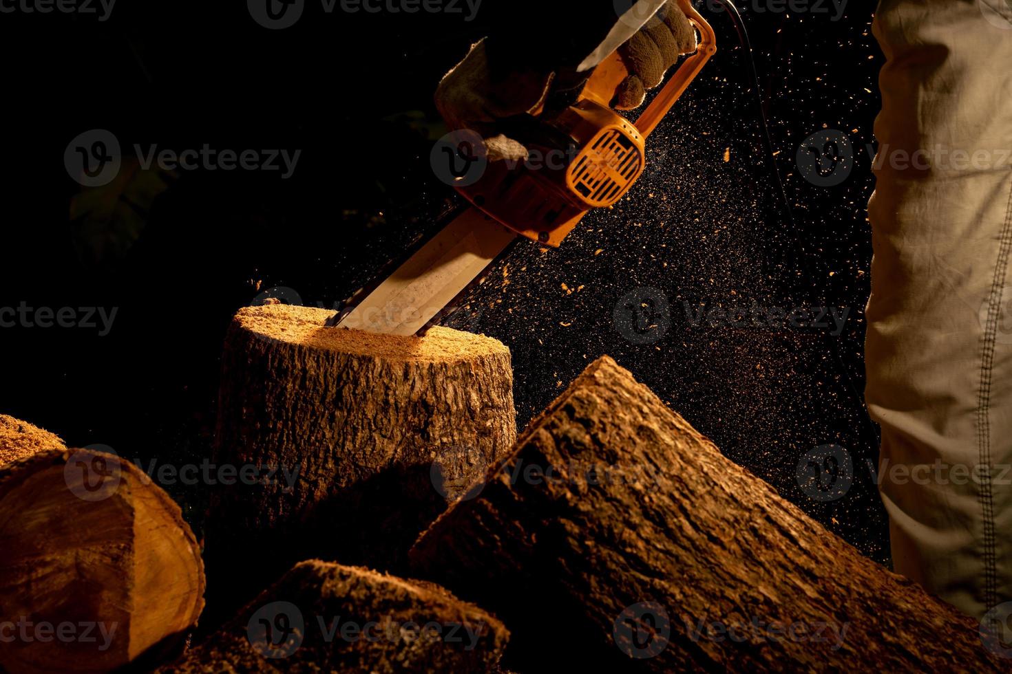 electric chainsaws cut trees in the forest for building a house and making firewood The concept of deforestation photo