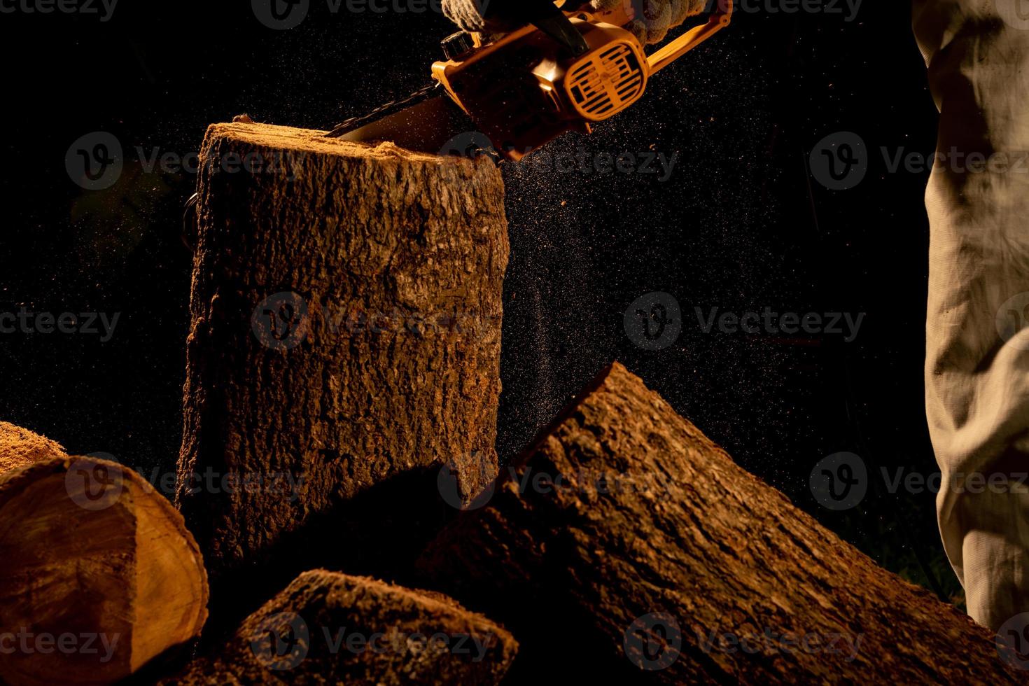 electric chainsaws cut trees in the forest for building a house and making firewood The concept of deforestation photo