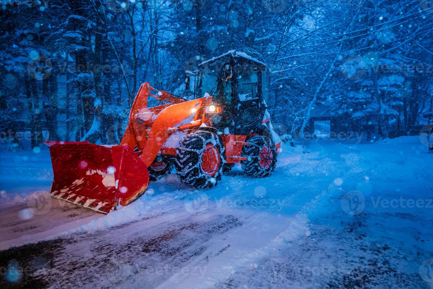 snow shovel tractor on a heavy snowy day at Heike No Sato Village in Tochigi Prefecture, Nikko City, JAPAN. soft focus. photo