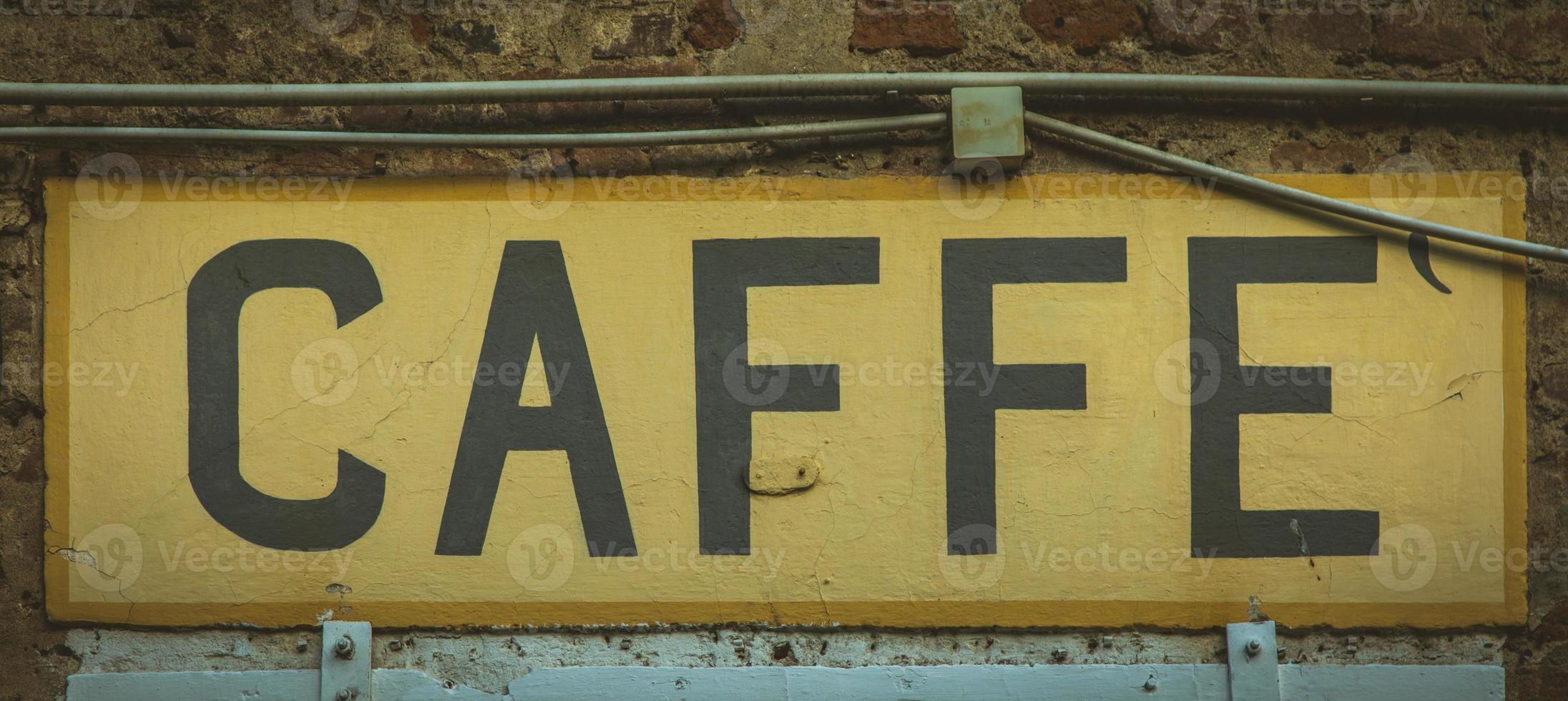 Old vintage coffee sign in Italy - Concept of retro, traditional design. photo