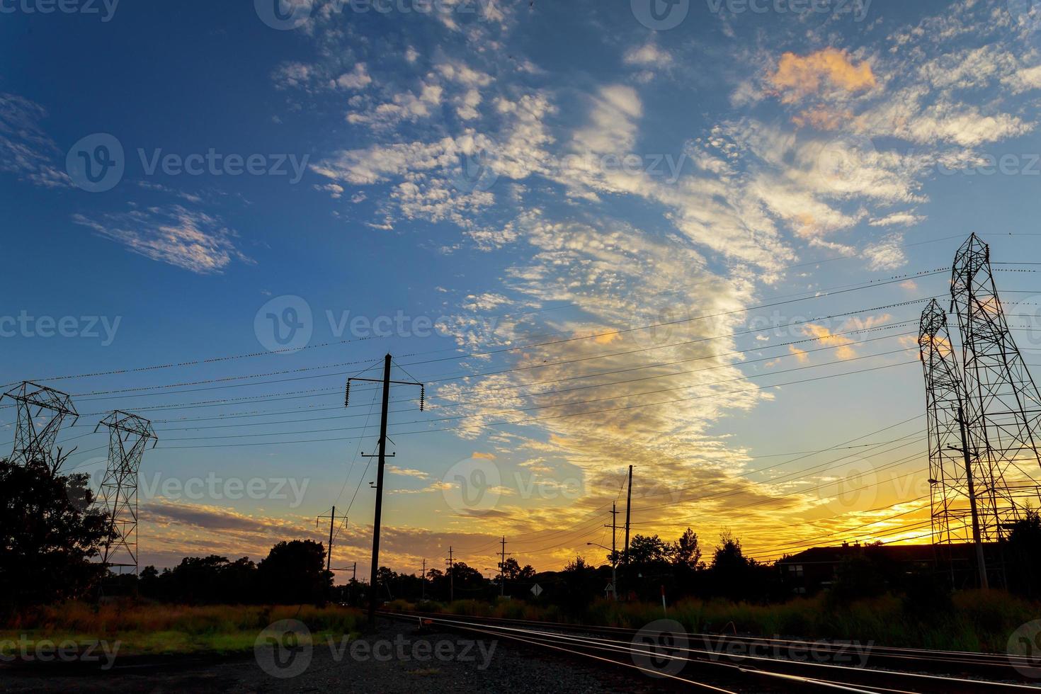 High voltage power pylons in sunset scene twilight photo