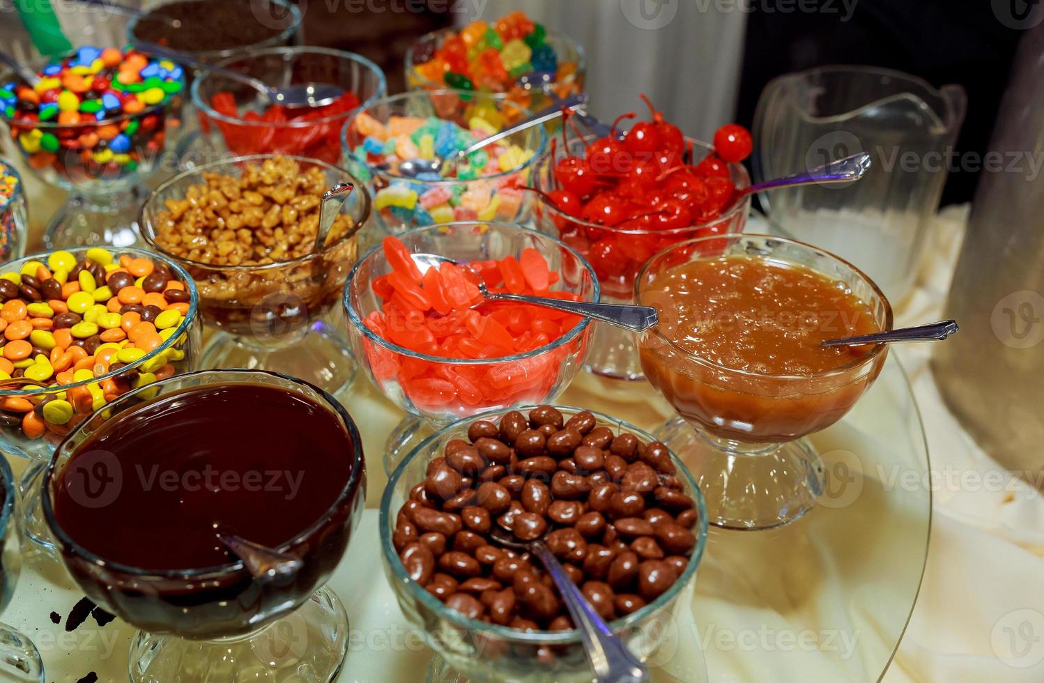 Candies in glass jars in candy shop photo