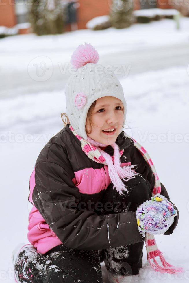 Little girl playing with snow photo