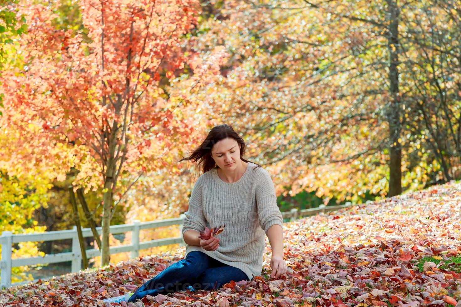 Cheerful woman relaxing in beautiful autumn day, photo