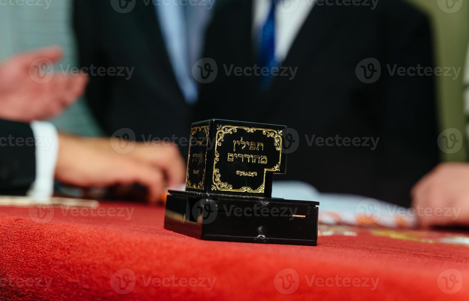 Hand of boy reading the Jewish Torah at Bar Mitzvah photo
