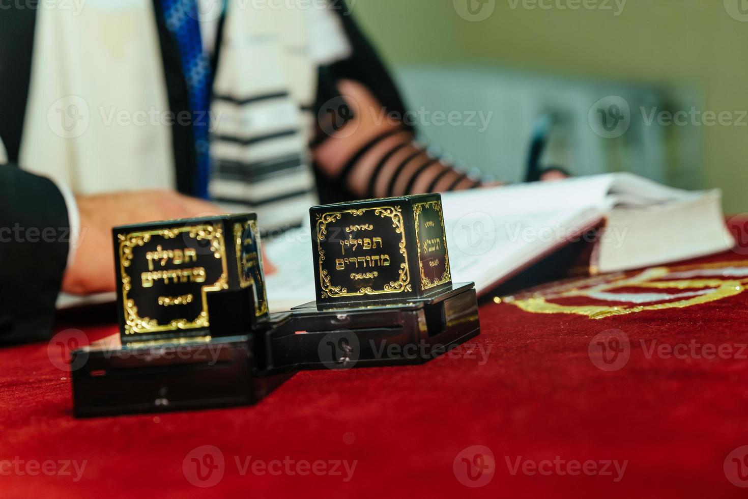 Hand of boy reading the Jewish Torah at Bar Mitzvah photo