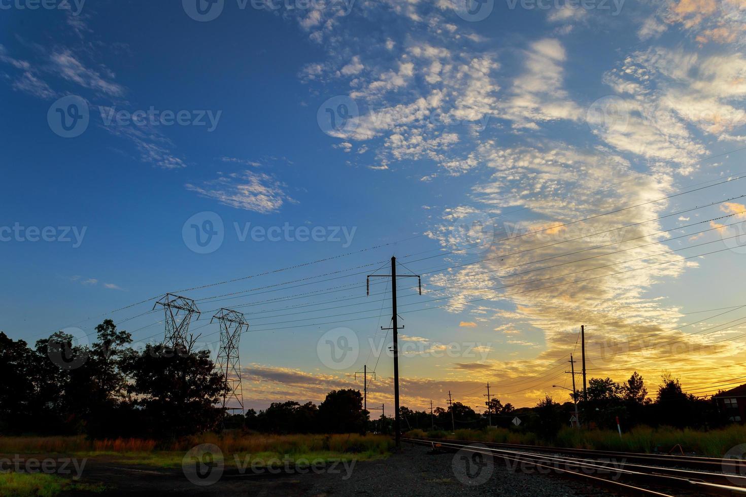 High voltage power pylons in sunset scene twilight photo