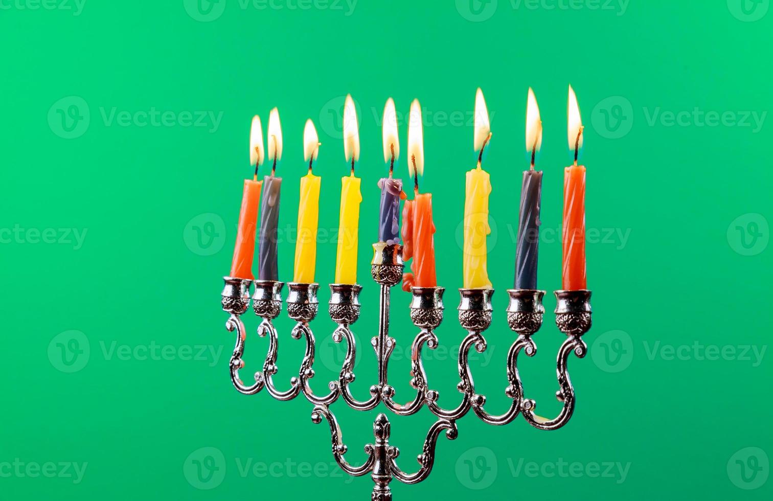 Hanukkah menorah with candles green background isolation photo