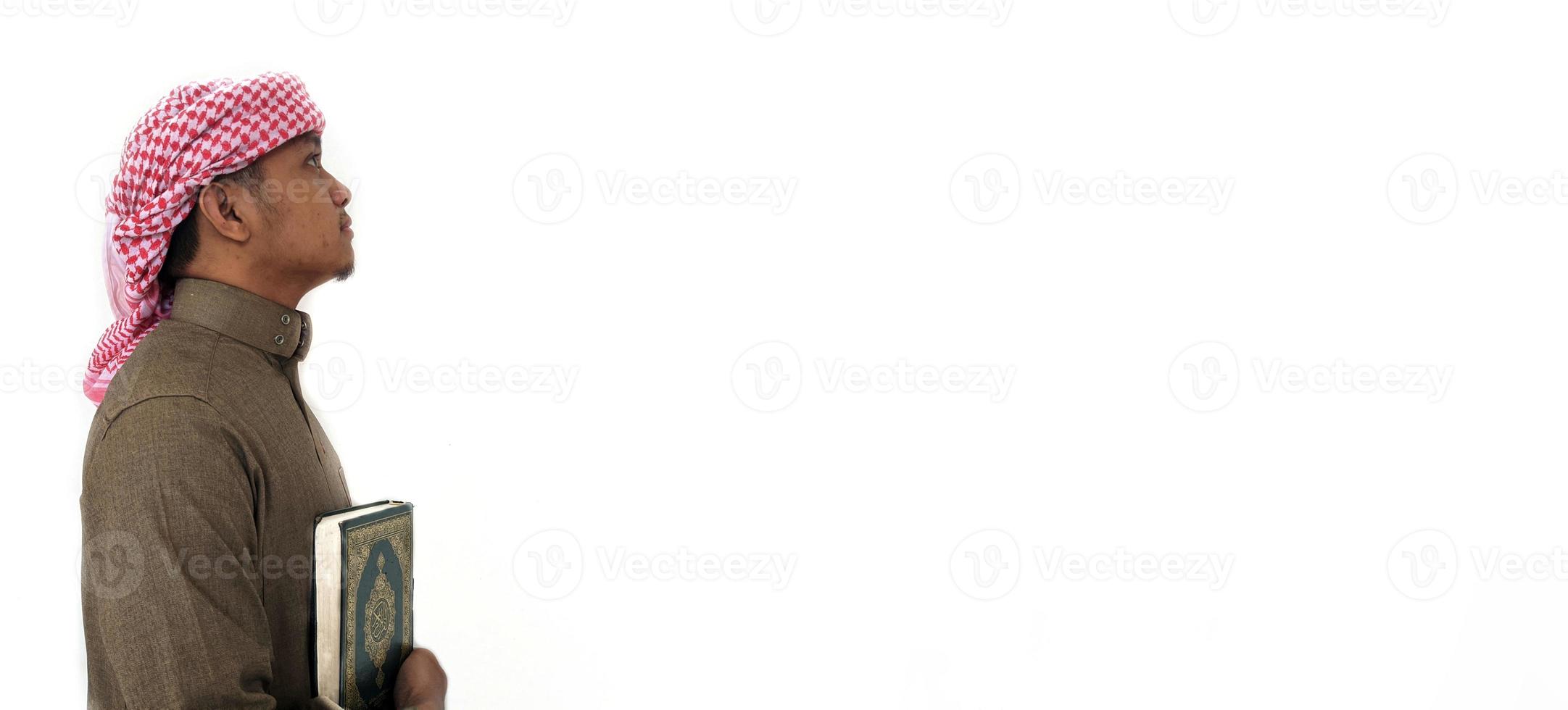 Man Holding and reading quran. Islamic Background photo