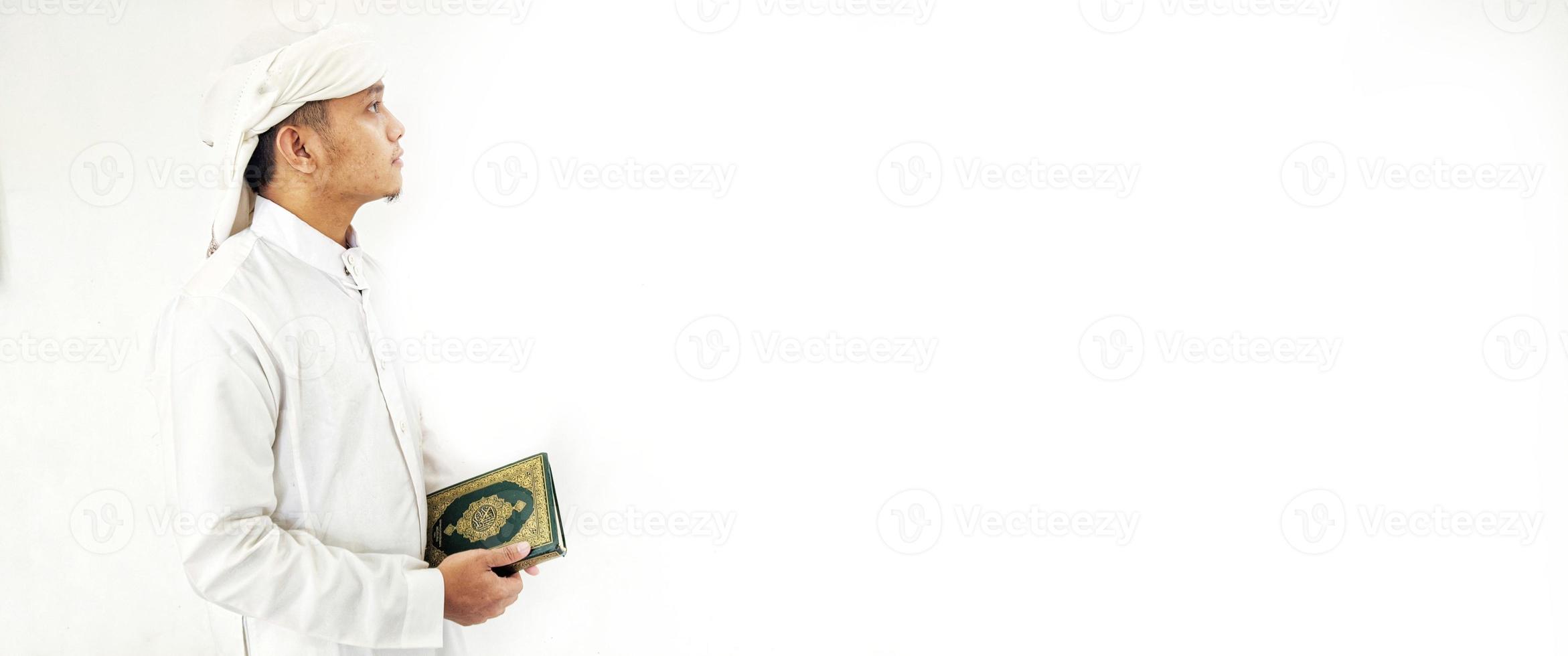 Man Holding and reading quran. Islamic Background photo