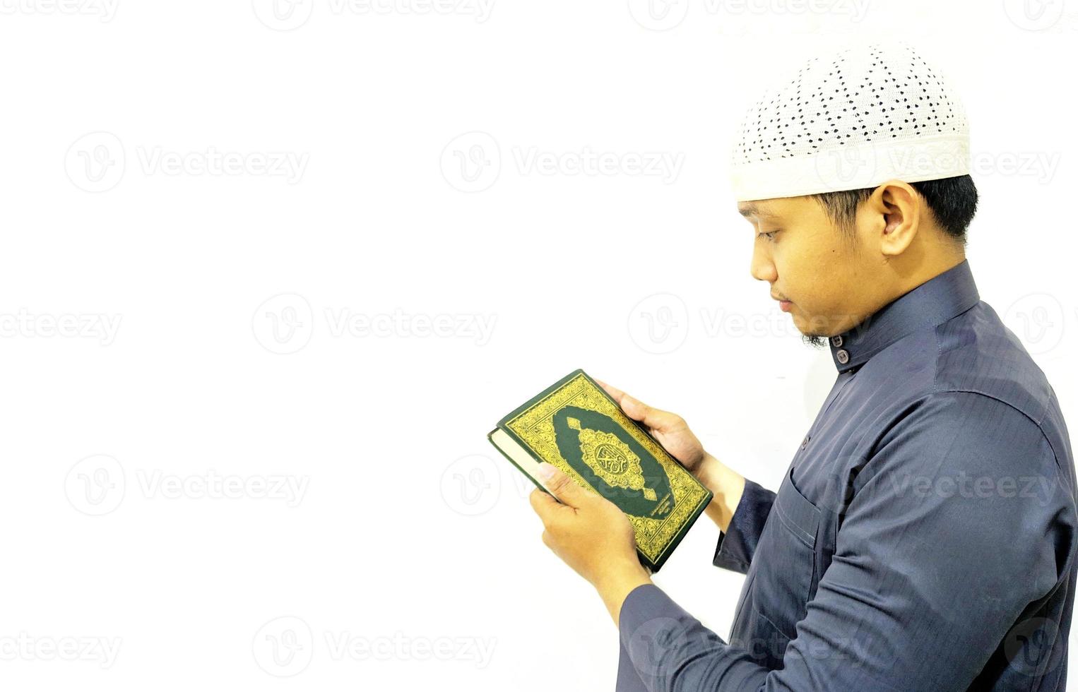 Man Holding and reading quran. Islamic Background photo