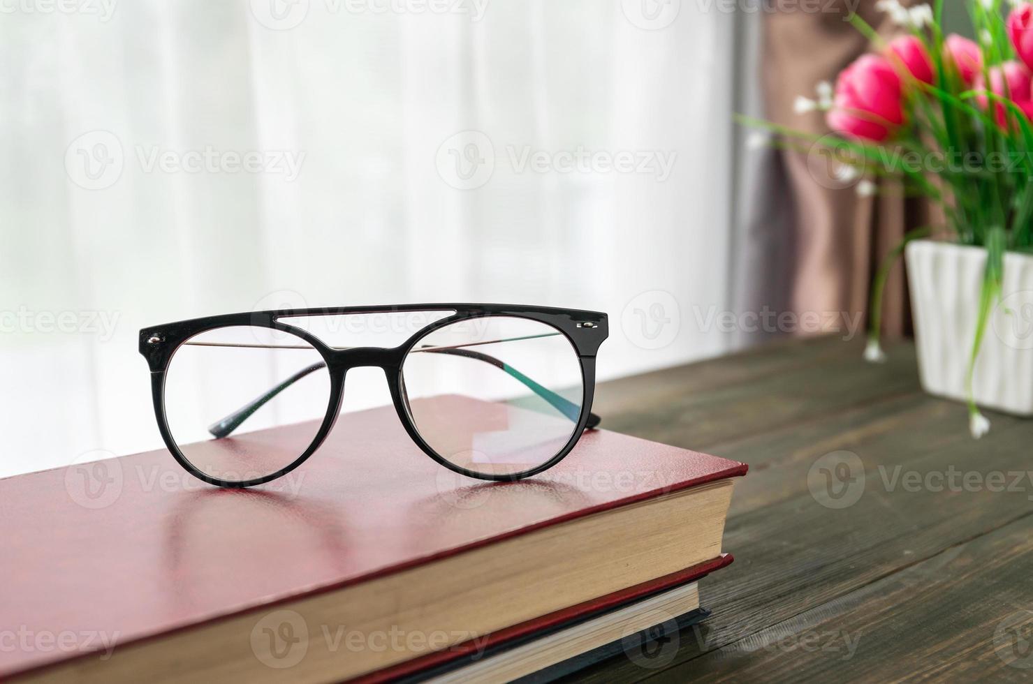 Eye glasses are placed on books photo