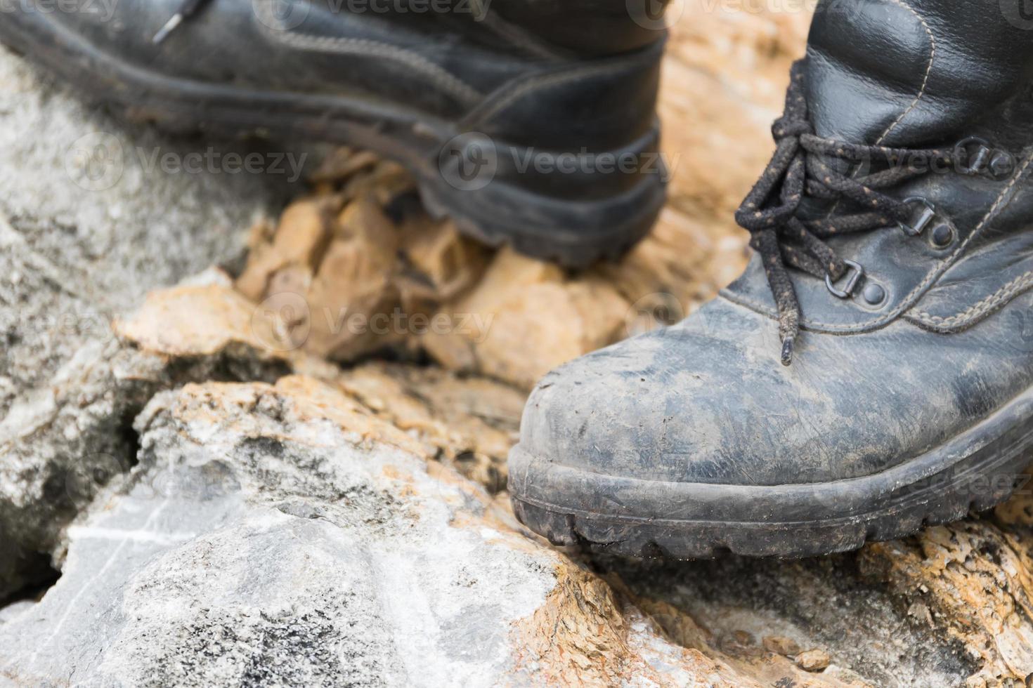 Trekking leather boot on the rock photo