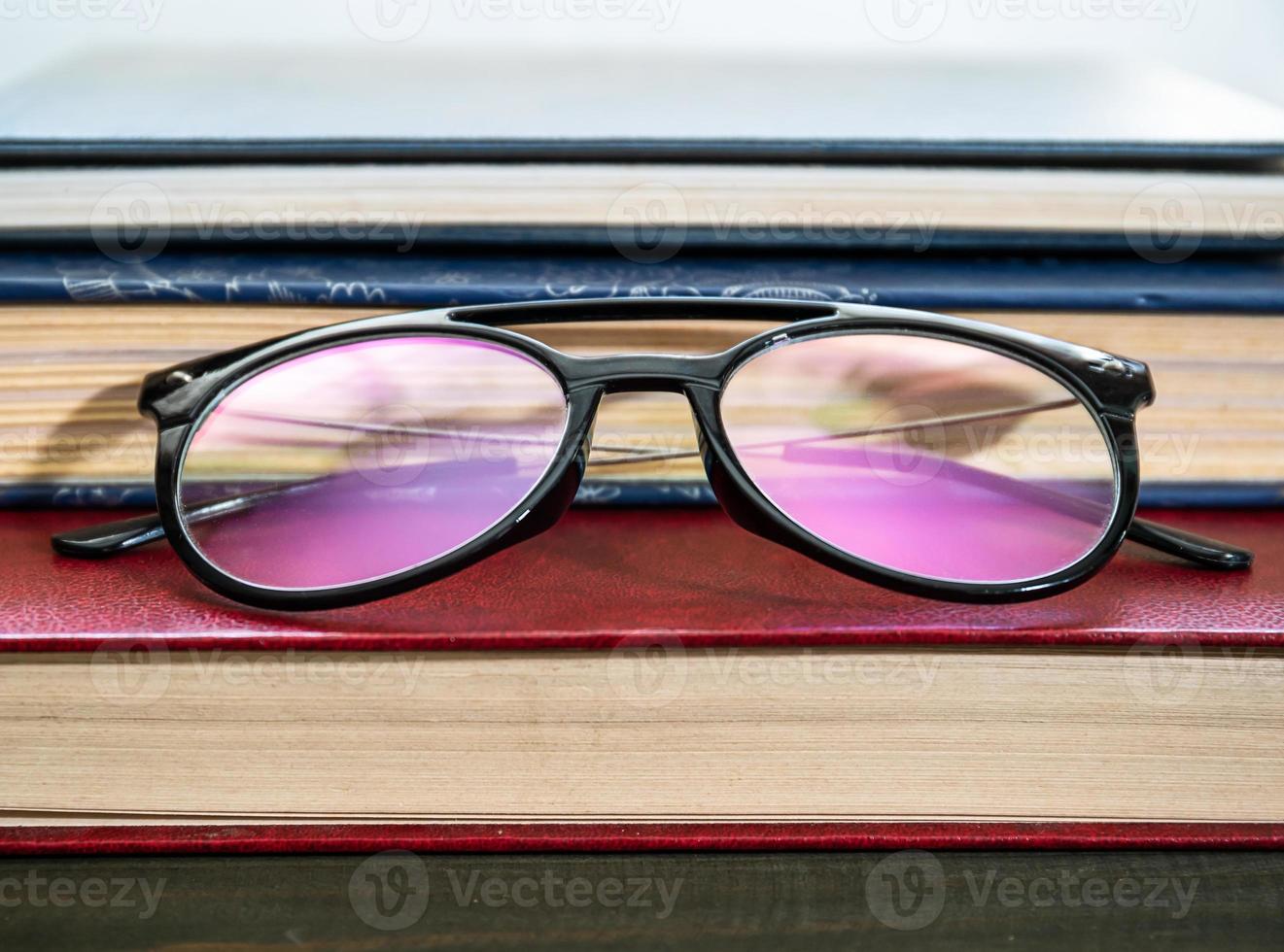 Close up Eye glasses and books photo
