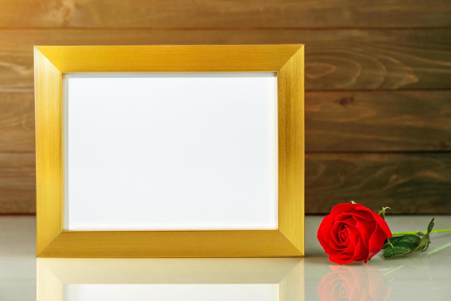 Picture mock up with golden frame on table with copy space photo