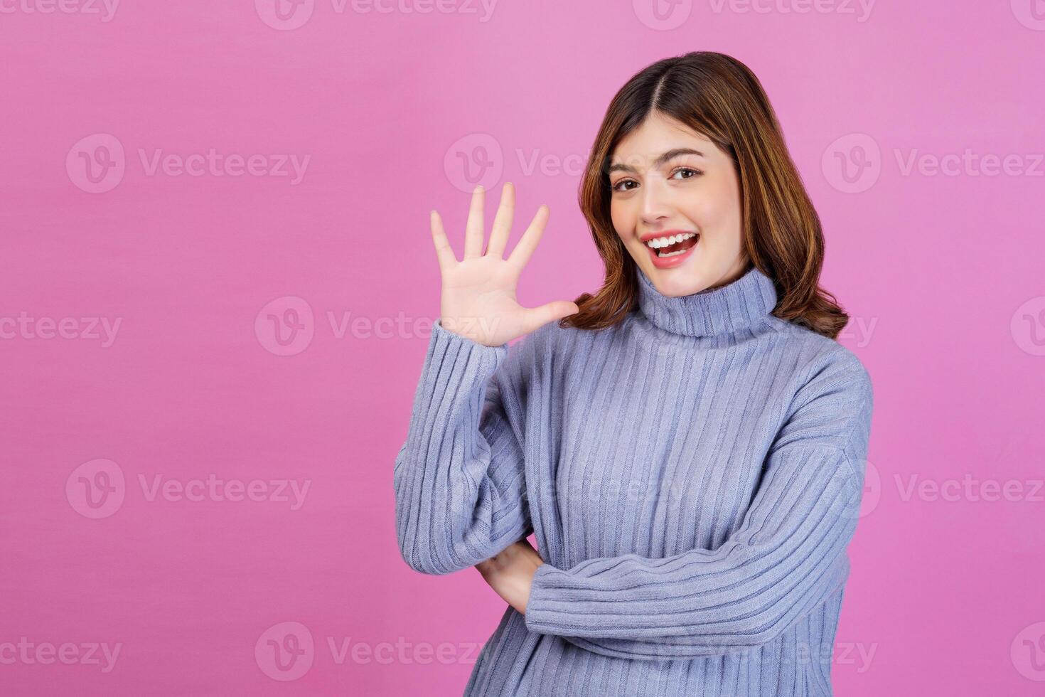 Portrait of Happy young woman pointing up with finger number five isolated over pink background photo