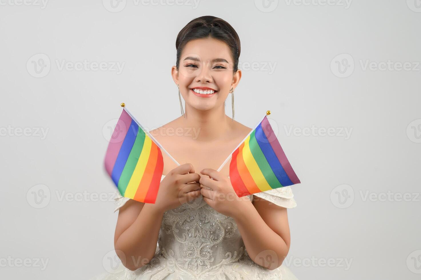 Young asian beautiful bride with rainbow flag on white background photo