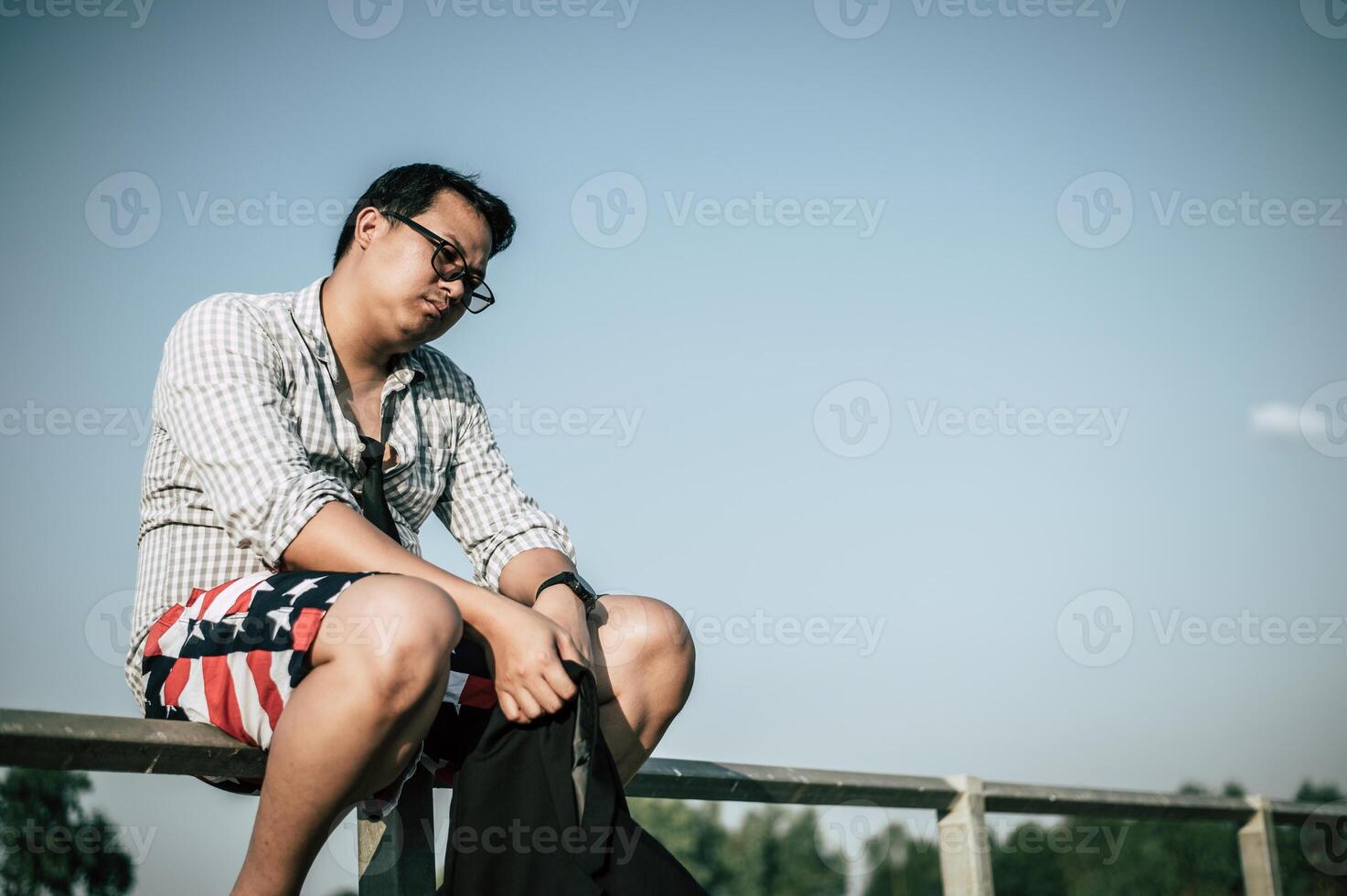 Young Asian Businessman with problems and stress outside corporate office photo