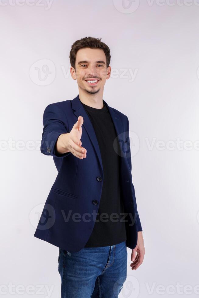 Portrait of smiling handsome businessman extend hand for handshake, look friendly, greet you, hi gesture, standing over white background photo