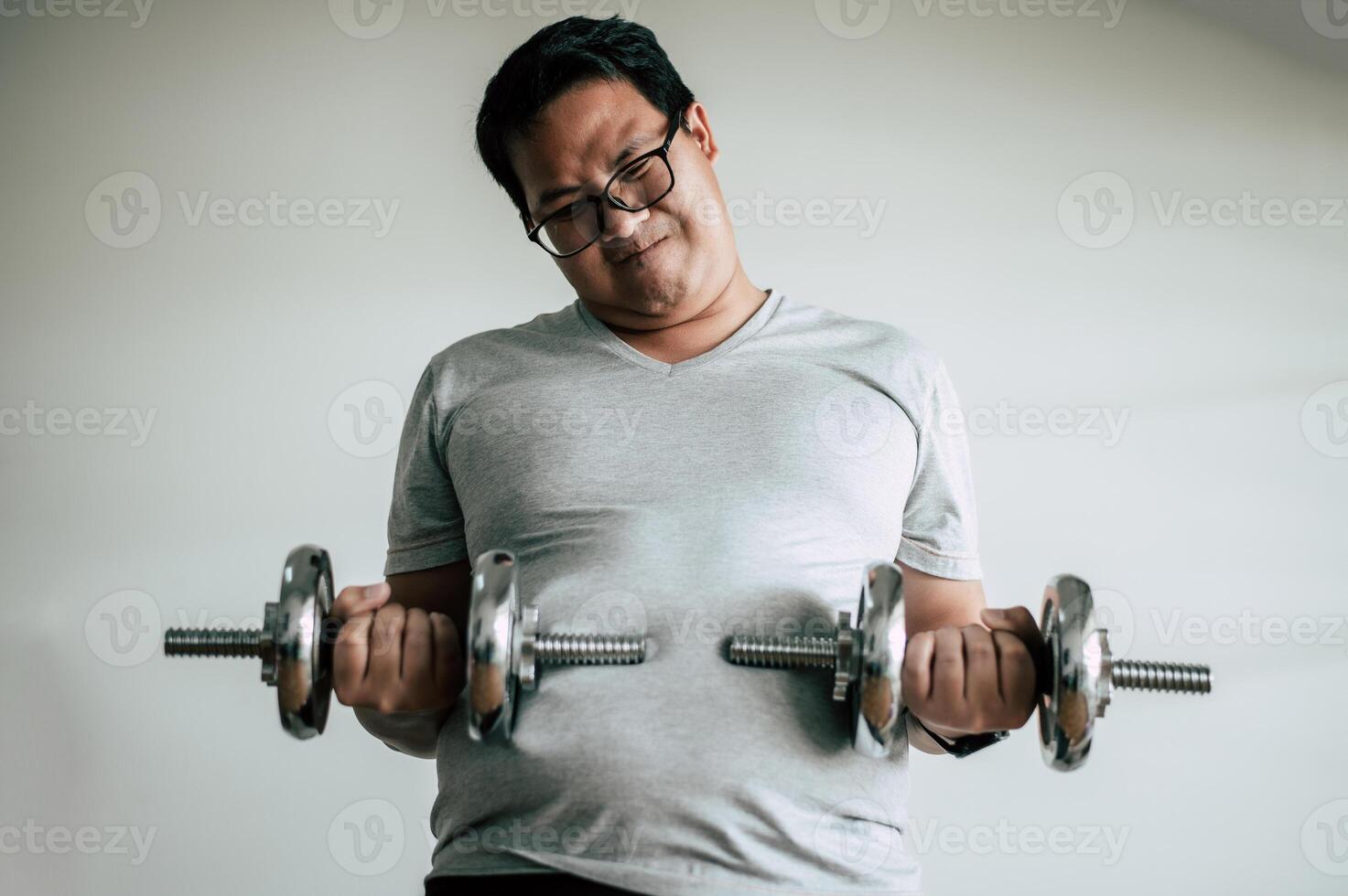 Funny fat man workout with dummbell photo