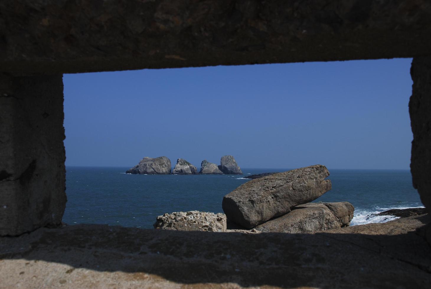 Rocks on the sea from the stone window photo