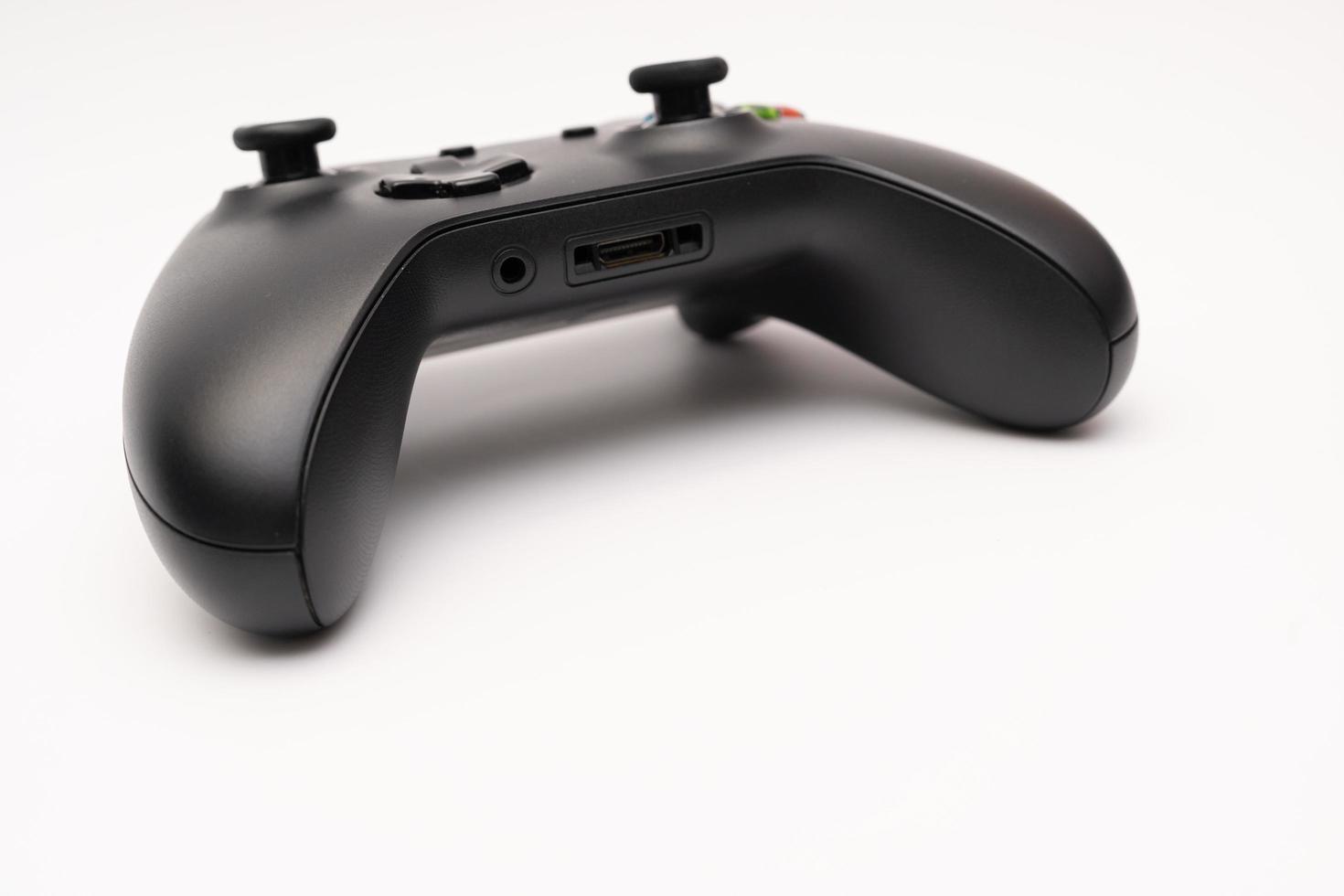 Samutprakarn Thailand Jan 23 2023 Wireless gamepad for the Xbox One on desk with keyboard. Black Xbox game controller. photo
