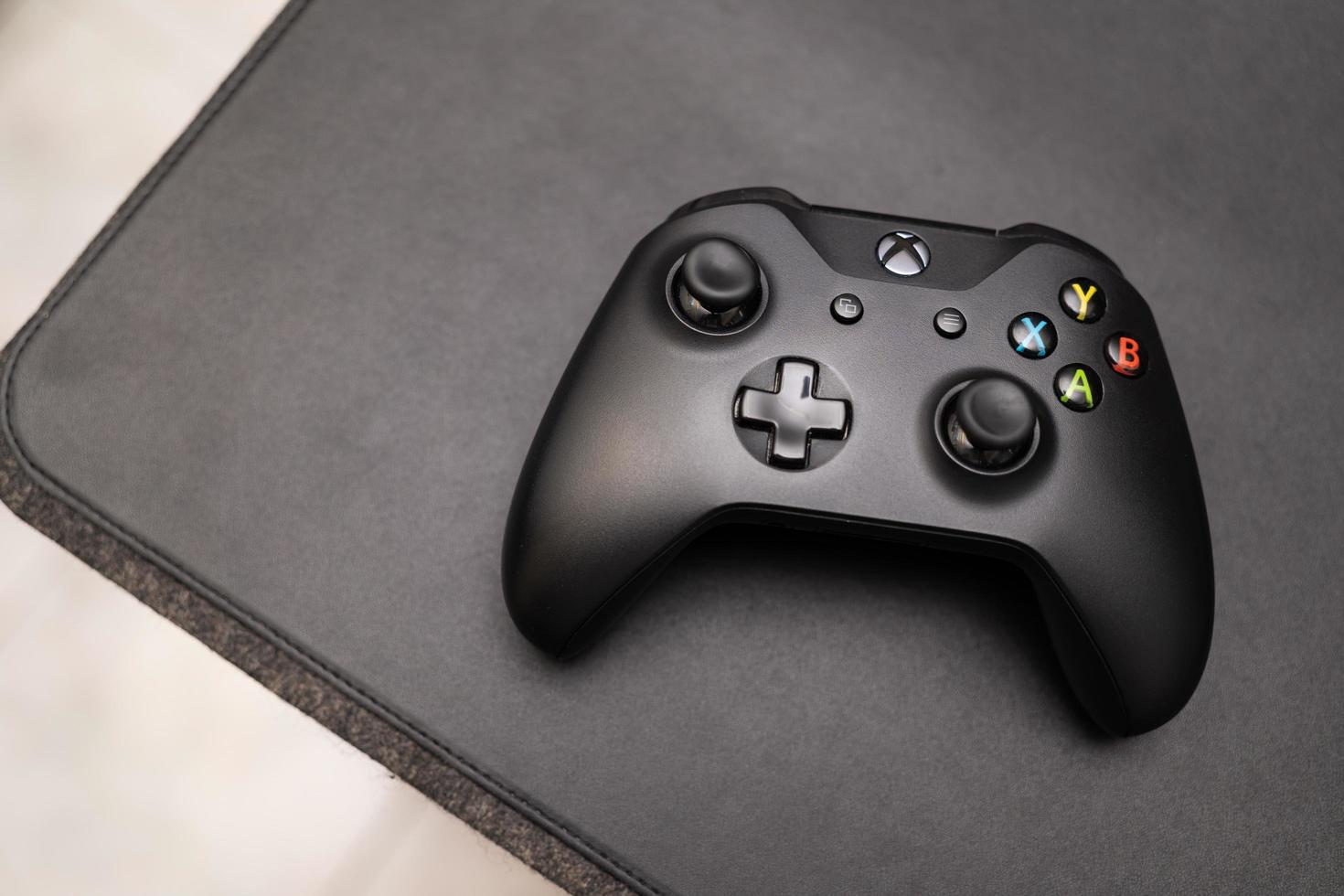 Samutprakarn Thailand Jan 23 2023 Hand holding Wireless gamepad for the Xbox One a home video game console produced by Microsoft. Black Xbox game controller. photo