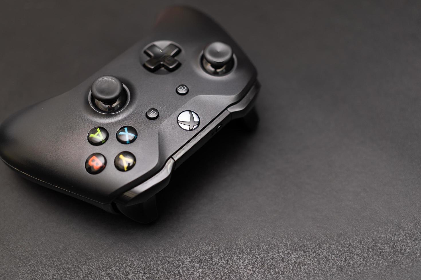 Samutprakarn Thailand Jan 23 2023 Hand holding Wireless gamepad for the Xbox One a home video game console produced by Microsoft. Black Xbox game controller. photo