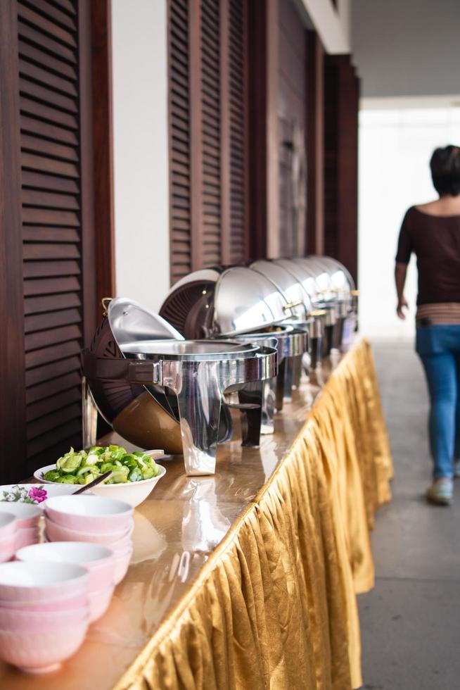 Bandung, Indonesia, 2020 - The offerings like food and candle on the top of the red Buddhist table during the praying from the monks photo