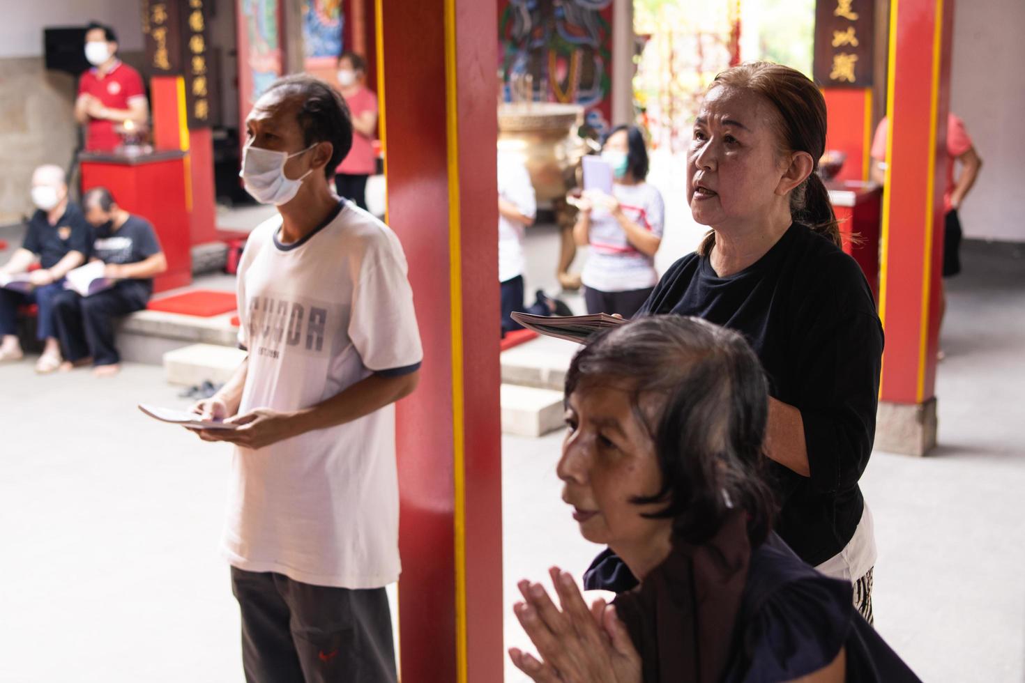 Bandung, Indonesia, 2020 - The visitor praying together with the monks in front of the offerings to the god photo