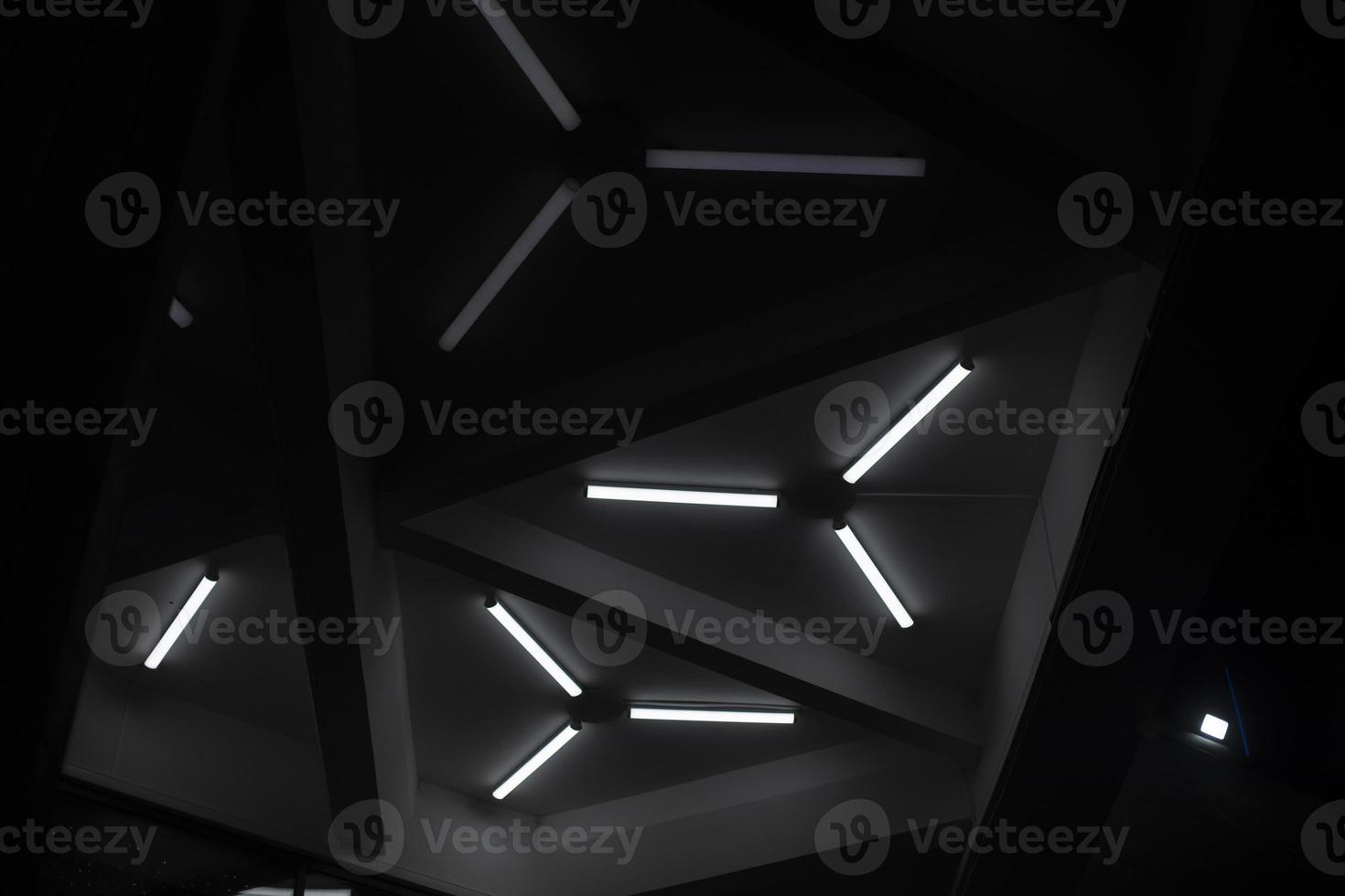 Triangular lamps on ceiling. Modern architecture. Light design. photo